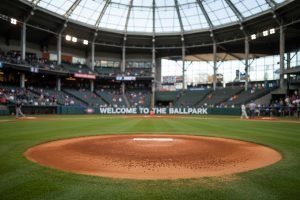 Baseball field with a pitcher's mound, stadium seating, and "Welcome to the Ballpark" sign
