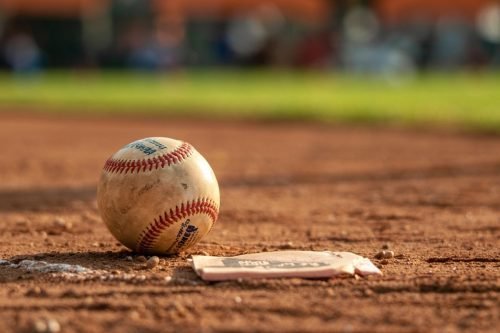 Baseball and home plate on a baseball field, close-up shot