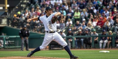 Baseball pitcher in pinstripes throwing a ball during a game